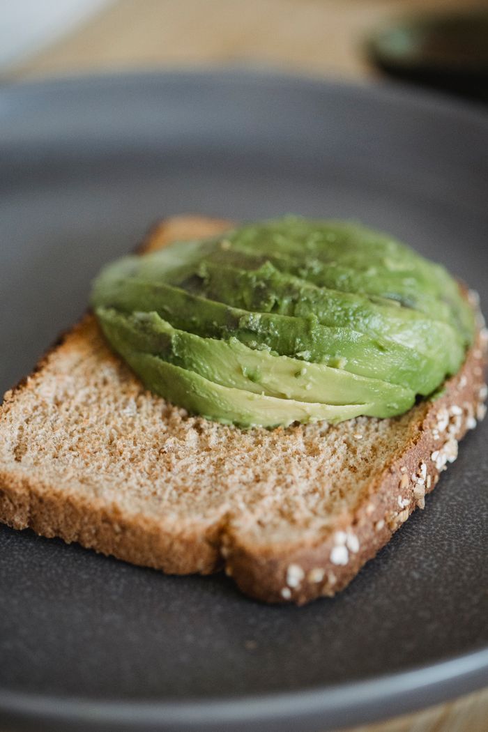 gallery-6 A detailed shot of sliced avocado on wholegrain toast, perfect for healthy eating visuals.